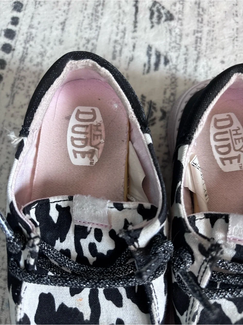Hey Dude Kids Black & White Cow Print Slip-Ons with Pink Lining